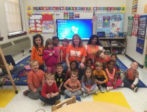 teachers and students wearing orange