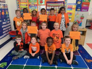 elementary children wearing orange shirts