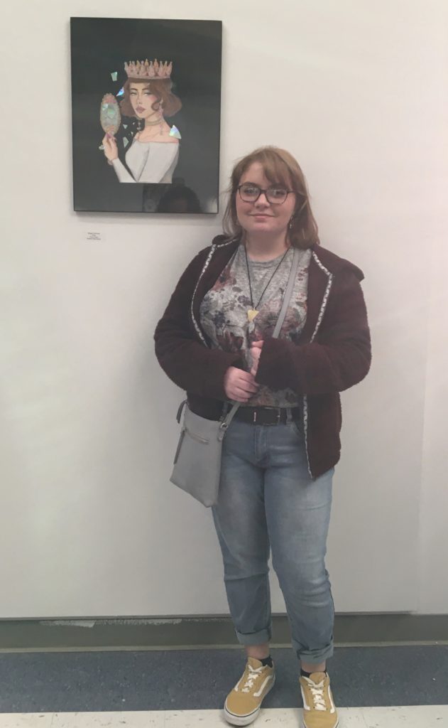 Morgan DePasse stands with her artwork