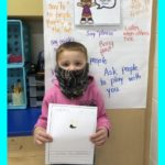 elementary students show drawing of how they show respect