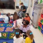 groups of older elementary students reading to younger elementary students