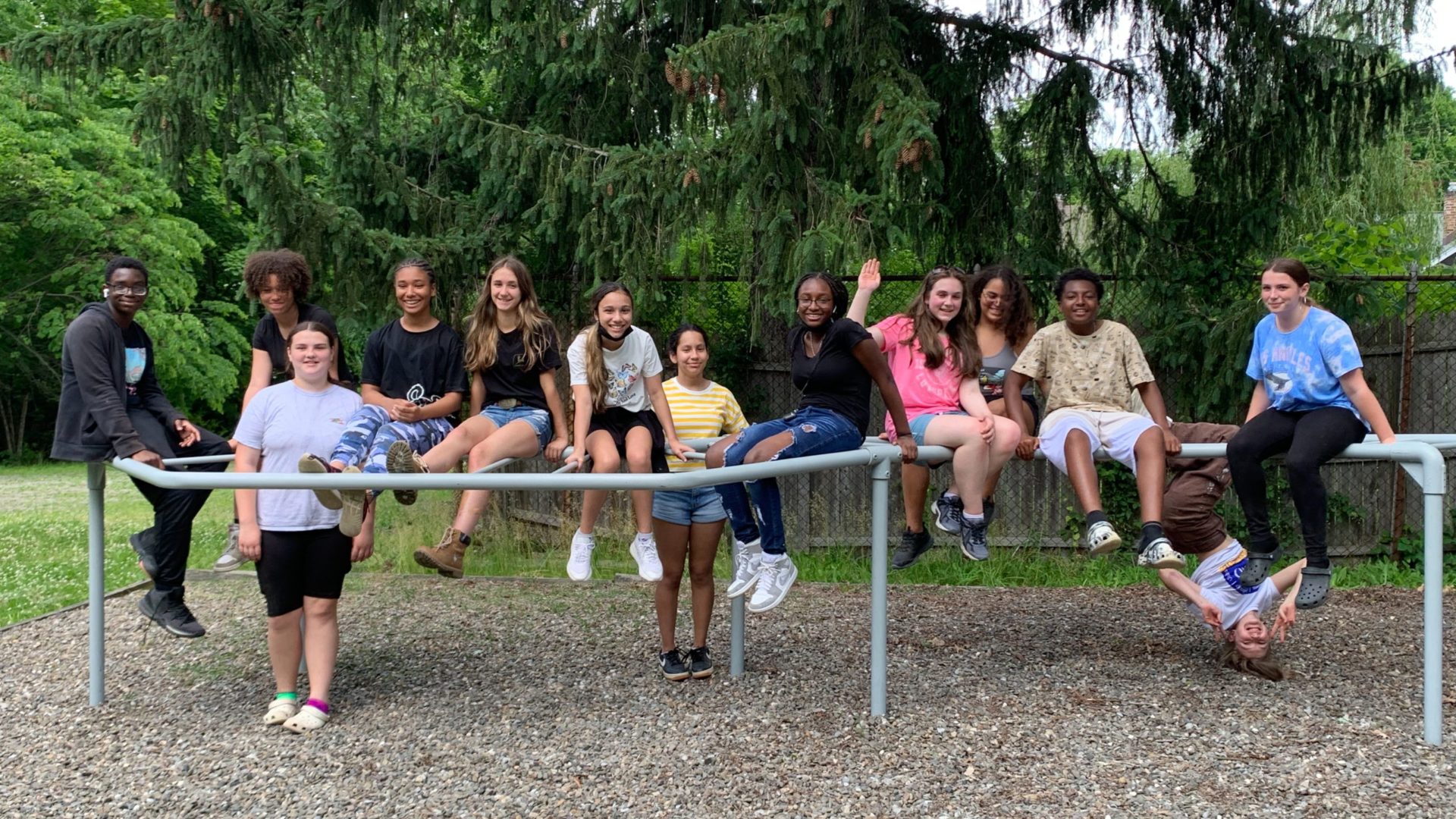 a group of junior high school students on a metal structure at an outodor park
